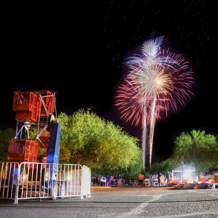 Kiddie ferris wheel under fireworks